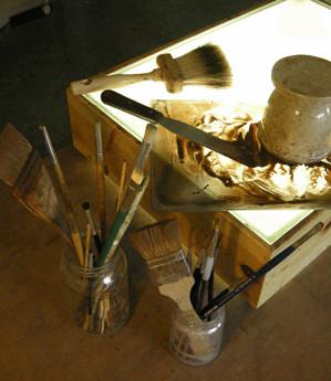 Brushes and tools used in traditional glass painting.